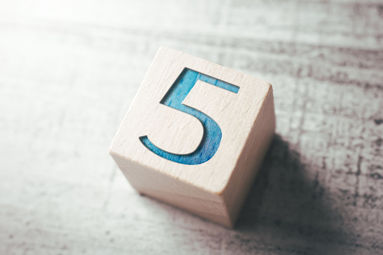 Number 5 On A Wooden Block On A Table